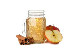 Apple, cinnamon and glass jar with cider isolated on blank background