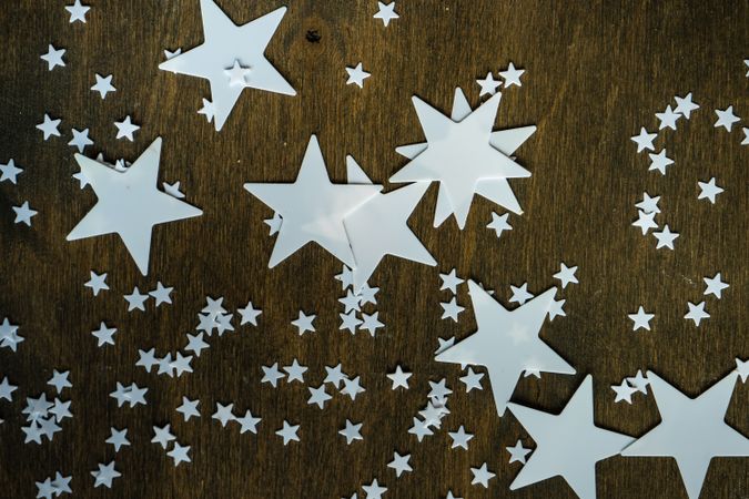 Star decorations scattered on wooden table