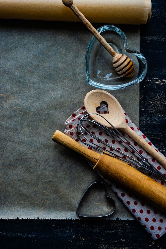 Heart themed baking equipment on parchment paper