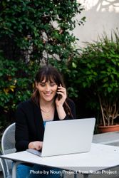 Female working outside with smartphone and laptop 5nBlD5