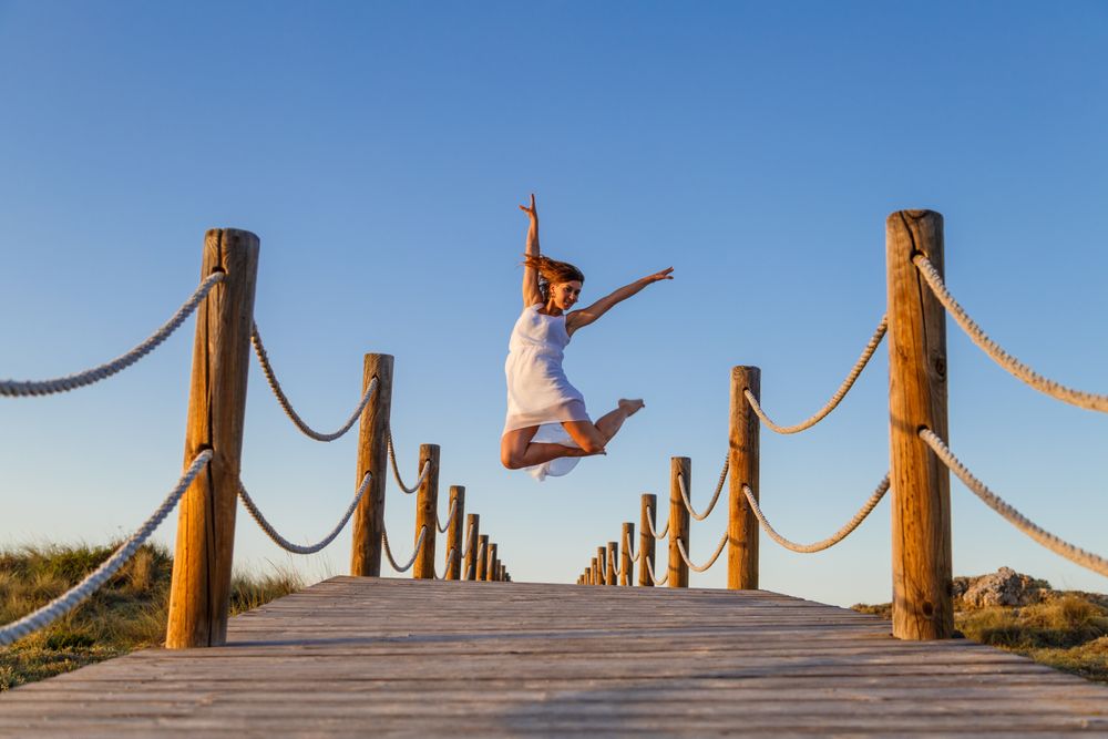 Woman posing in air on footbridge
