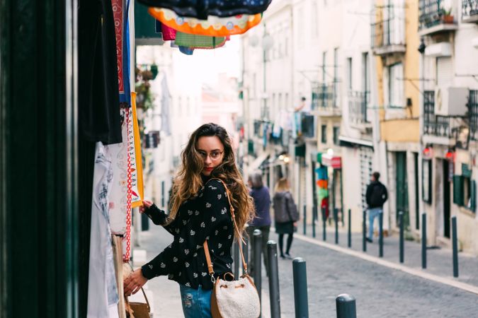 woman exploring street stall with clothes