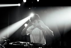 Unsaturated photo of a disc jockey at turntables