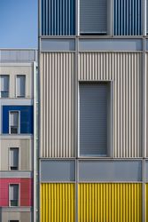 Facade of modern multicolored building with narrow windows