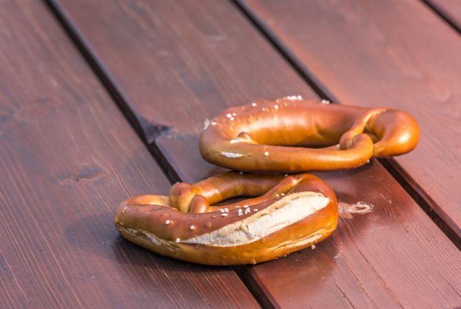 Two pretzels on wooden background
