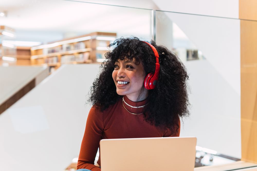 Happy female listened to music from laptop