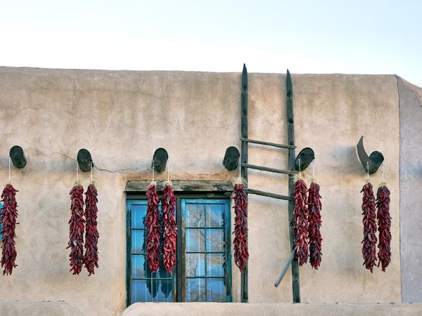 Old-style adobe building adorned with hot-pepper chiles in Taos, New Mexico