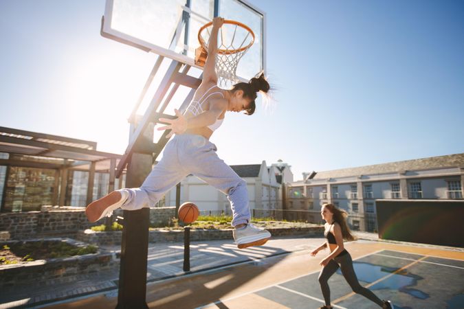 Two women playing basketball together