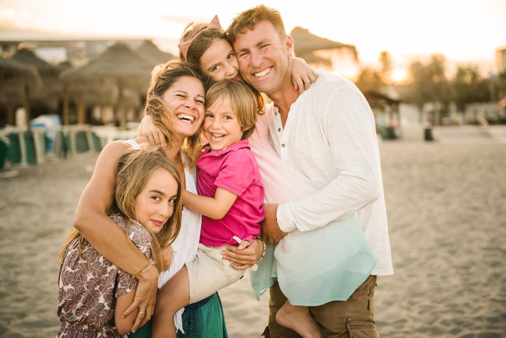 Beautiful happy family with children on beach
