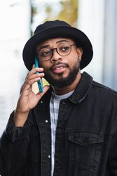 Hipster man getting good news during phone call