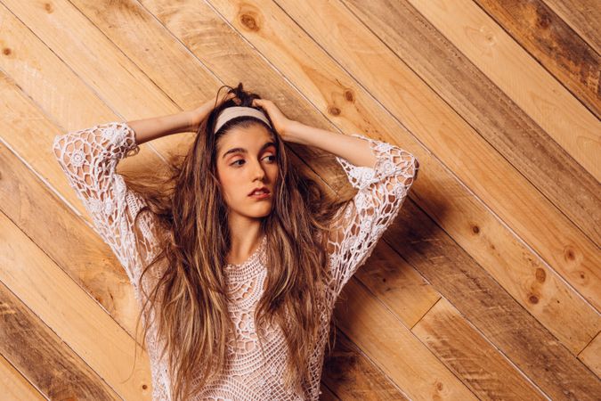 Young woman posing on wooden background