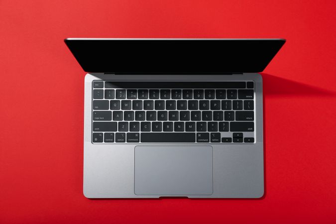 Top view of open laptop on red desk