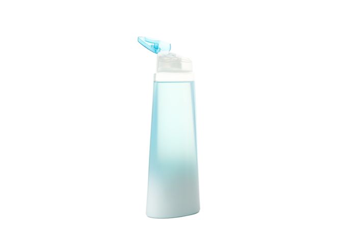 Blank plastic shampoo or lotion bottle isolated on light background