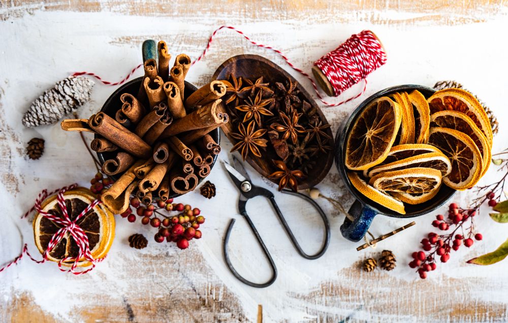 Top view of dried orange slices and anise star and cinnamon sticks on wintry table