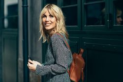 Happy blonde female wearing casual clothes outdoors with cell phone, copy space
