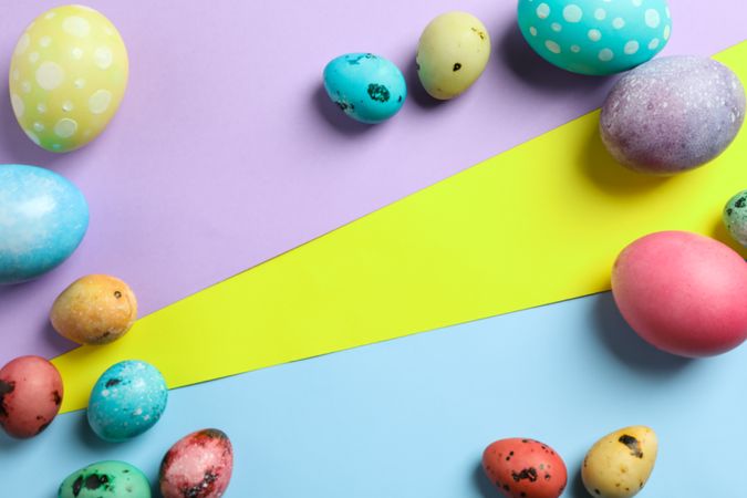 Decorated easter eggs on colorful background. Festive tradition. Space for text. Top view