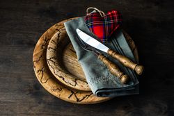 Valentine's day card concept of tartan heart decoration on rustic plate