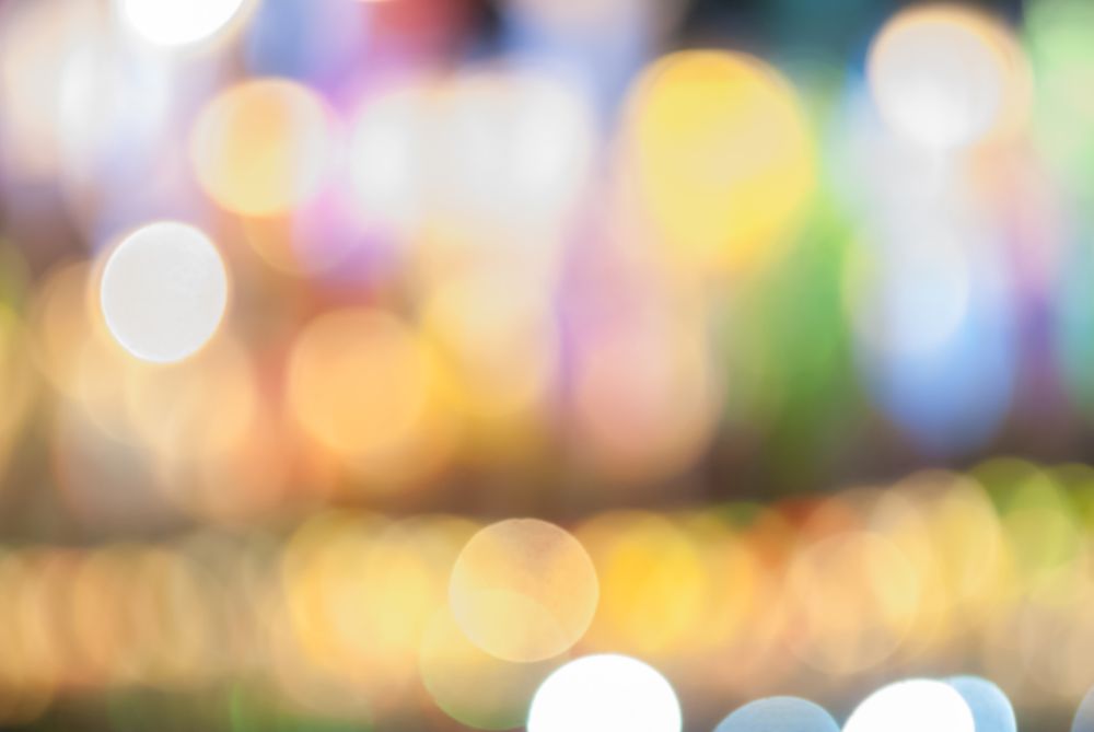 Defocused abstract bokeh lights christmas background, blur of bokeh circle light christmas festive backdrop concept.