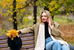 Woman on park bench in autumn