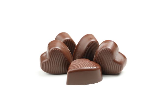 Tasty chocolate candies in the heart form isolated on studio background