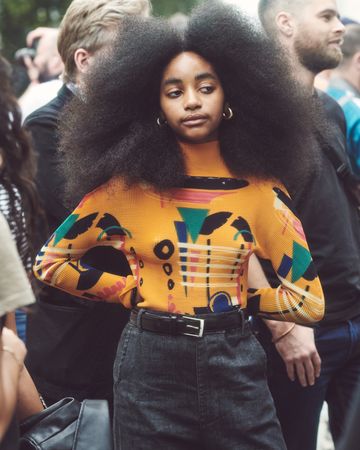 London, England, United Kingdom - September 18 2021: Woman with large afro and sweater and skirt