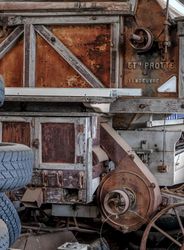 Close up of vintage harvester farm equipment in shack