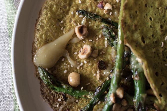 Served vegetarian crepe with oats and asparagus