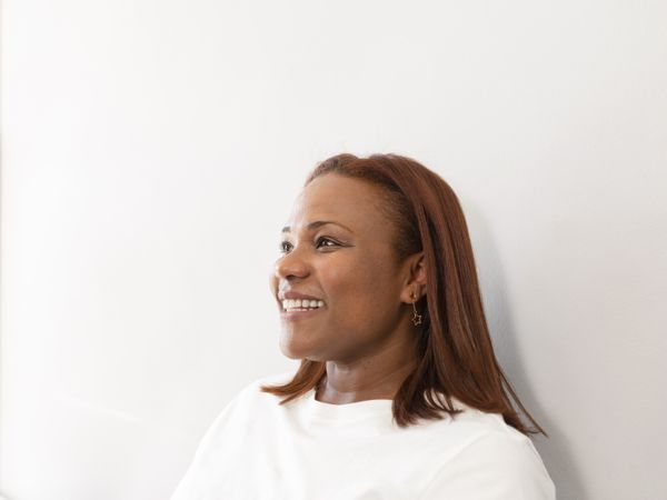 A portrait of a Black woman smiling at the dental clinic