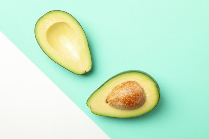 Ripe fresh avocado on two tone background, top view