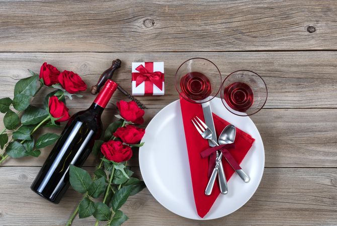 Happy Valentine dinner setting on rustic wood