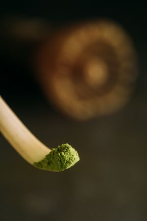 Green matcha tea powder and bamboo whisk
