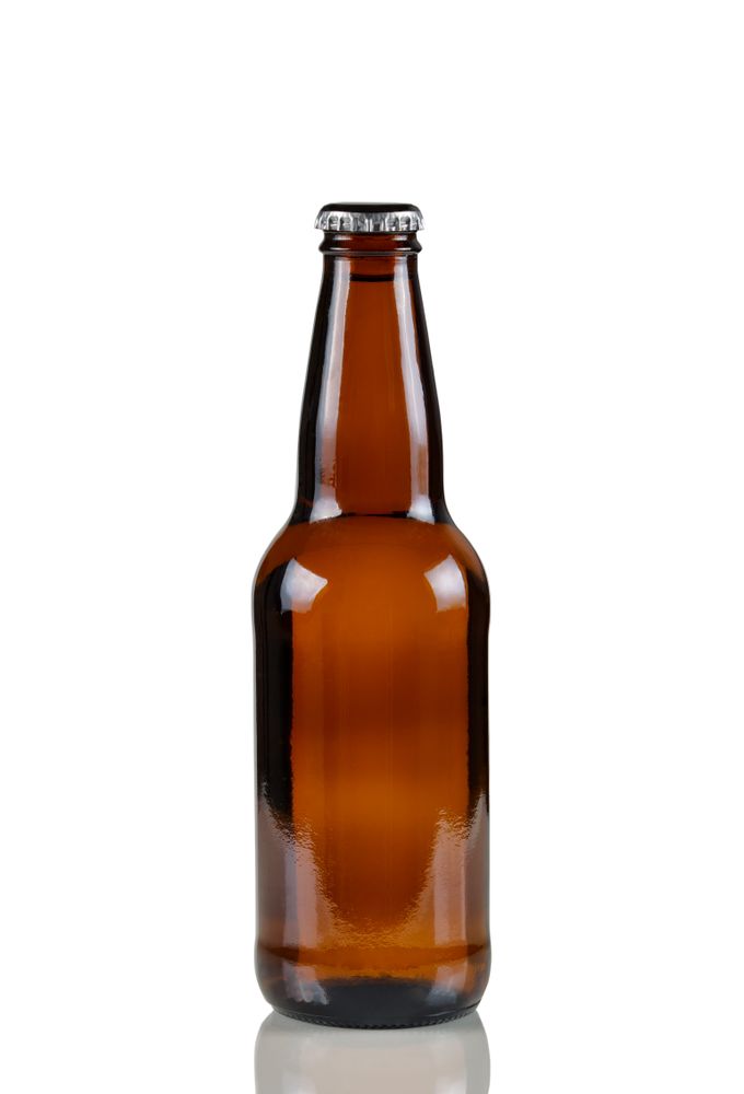 Unopened beer bottle with reflection