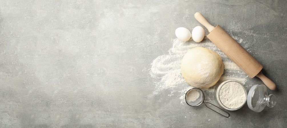 Concept for baking with dough on gray background