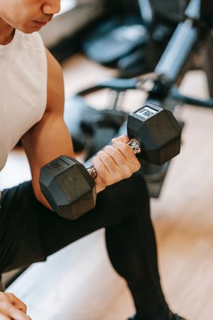 Cropped image of a man training his arm with a dumbbell