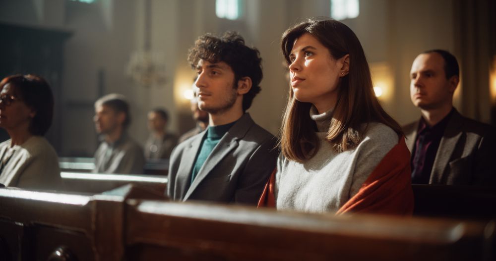 Group Of Faithful Parishioners In Grand Old Church Listening to Sermon.