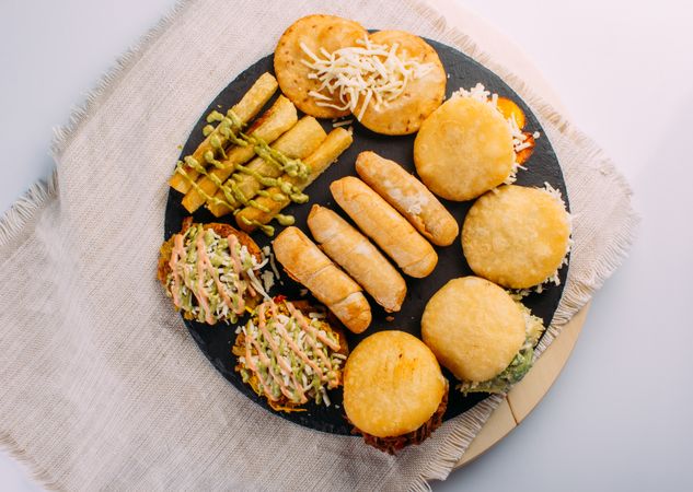 Top view of Venezuelan food tasting dish, the dish has arepas, tequeños, yuca and patacones