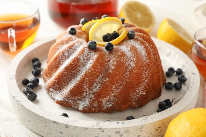 Cake with powder sugar and lemon, close up