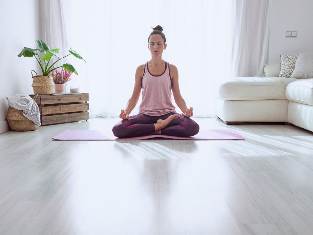 Woman meditating on sunny morning