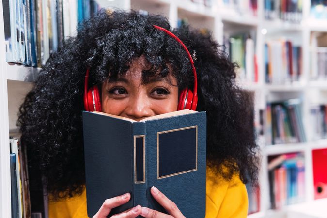 Content female student with book in library