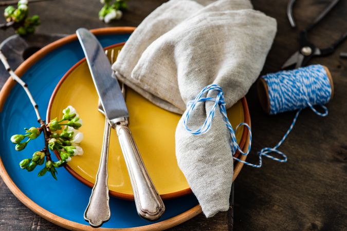 Colorful spring table setting with budding branch