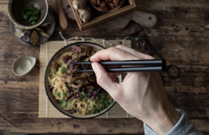 Miso noodles with egg plants and shiitake in bowl on table