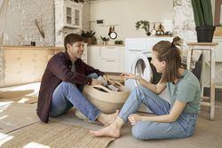 Couple taking clothes from basket