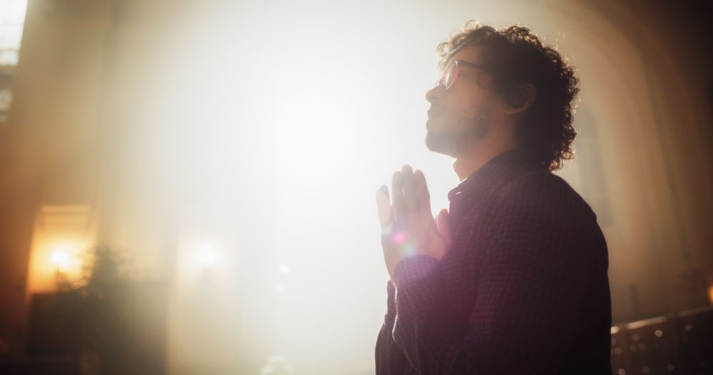 Young Christian Man Sits Piously in Majestic Church