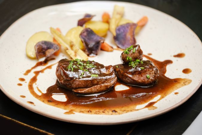 Appetizing beef steak with assorted vegetables and sauce