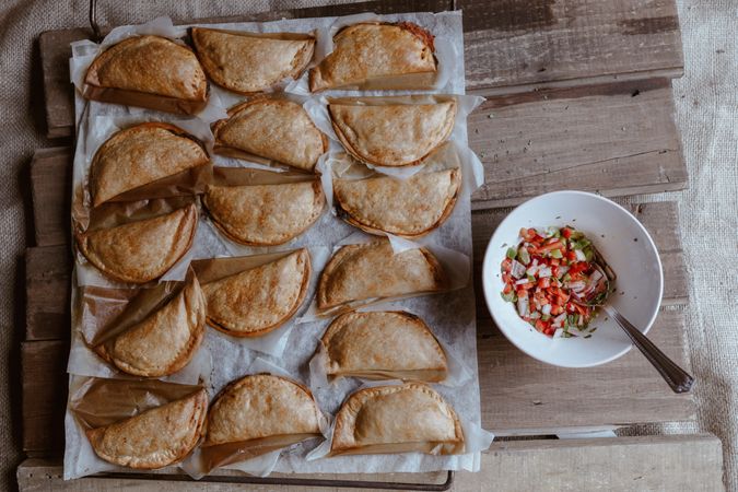 Baking tray with composed freshly baked pies patty