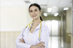 Portrait of female doctor with stethoscope in hospital hallway