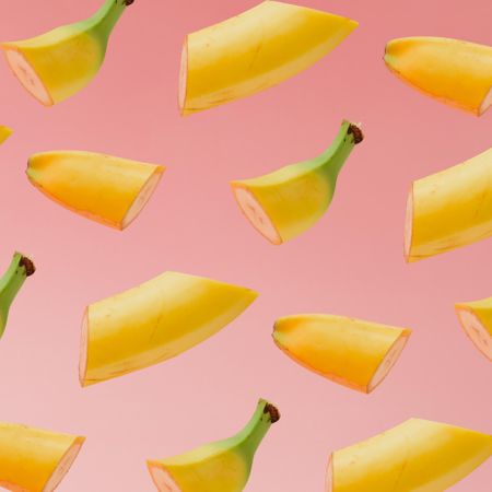 Sliced banana pattern on pastel pink background