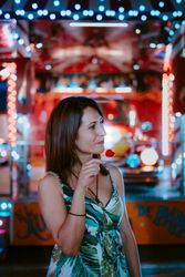 Woman with lollipop in amusement park