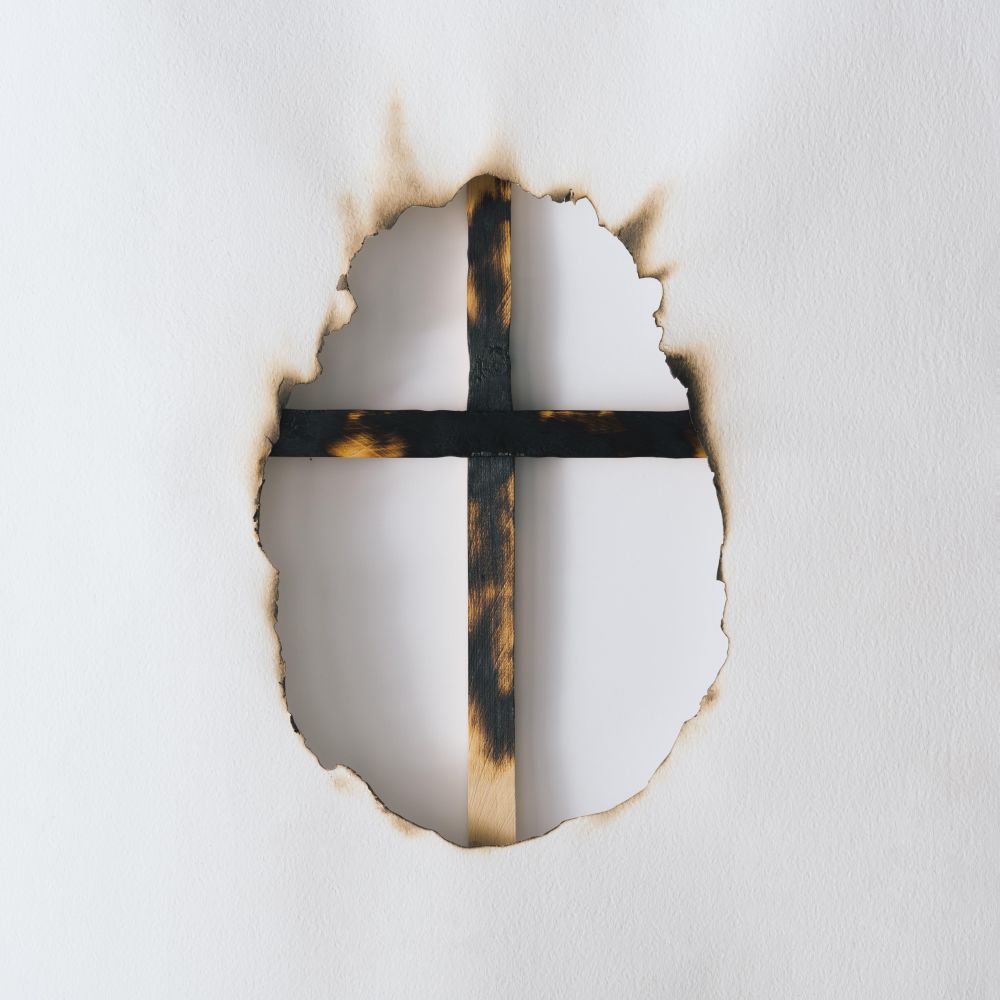 Canvas or paper burnt in egg shape with cross