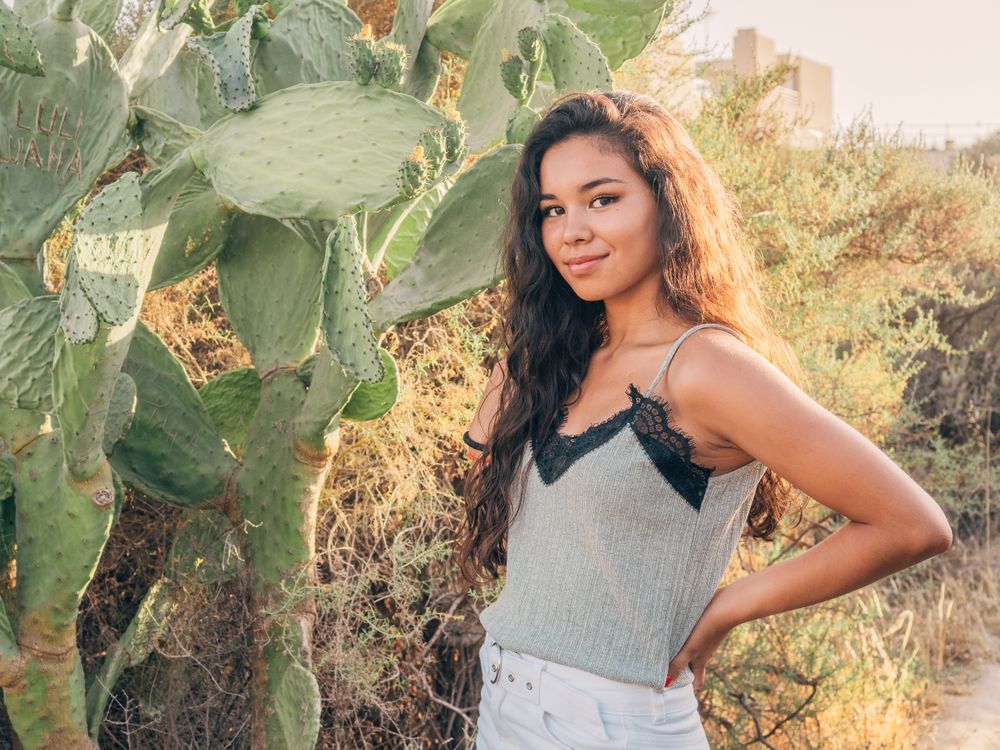 Playful trendy young woman in deserted countryside